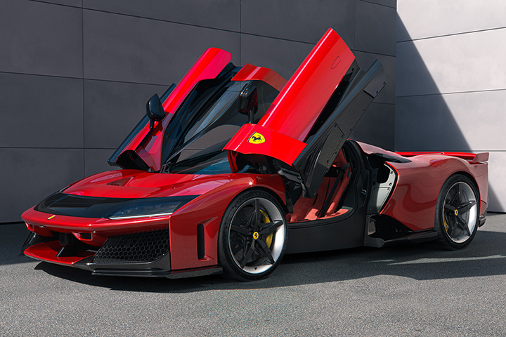 Red Ferrari F80 seen from the front three-quarter angle with both doors raised